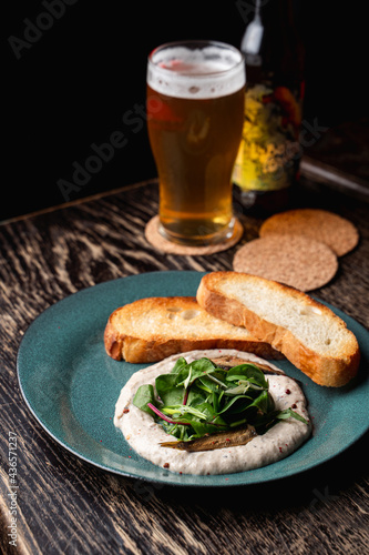 Jewish forshmak with toasted wheat bread and spats on a dark wooden table