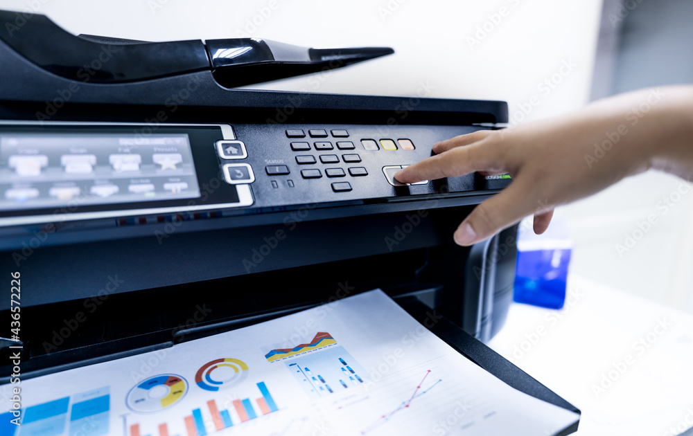 Office worker print paper on multifunction laser printer. Copy, print, scan, and fax machine in office. Modern print technology. Photocopy machine. Document and paper Professional scanner. Stock 写真 | Adobe Stock