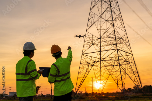 Fototapeta Team work of Engineers location help Technician use drone to fly inspections at