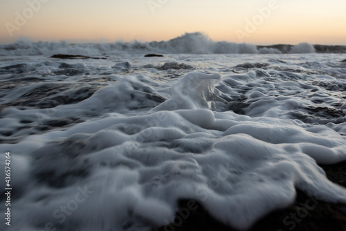 beach view Colorful dawn over the sea. Nature composition.Waves glisten in the rays of the sun in gold.