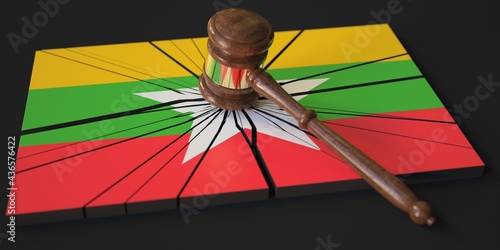 Block with flag of Myanmar hit by judge's gavel. Court related 3d rendering