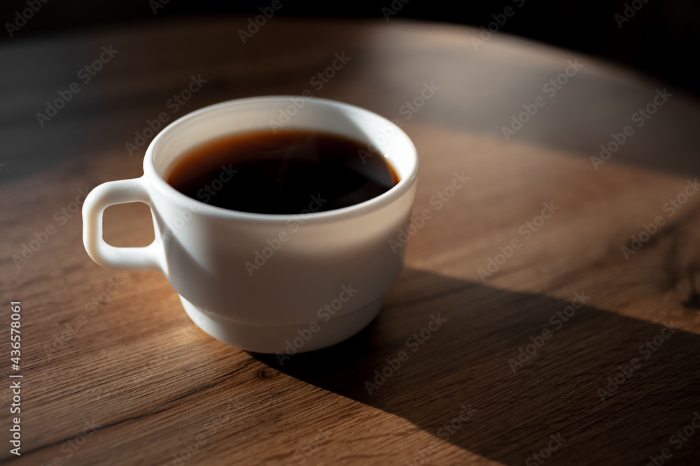 Obraz premium Close-up of ceramic coffee cup on wooden table.