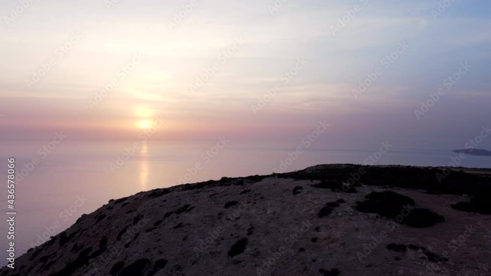 Aerial view of a couple on a mountain peak at sunset. Freedom or hiking concept Aerial view of a couple on a mountain peak at sunset. Freedom or hiking concept
