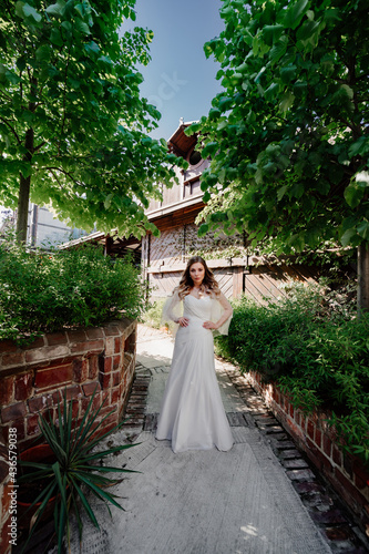 bride on the footpath in the garden. Wedding make-up.  © andrey