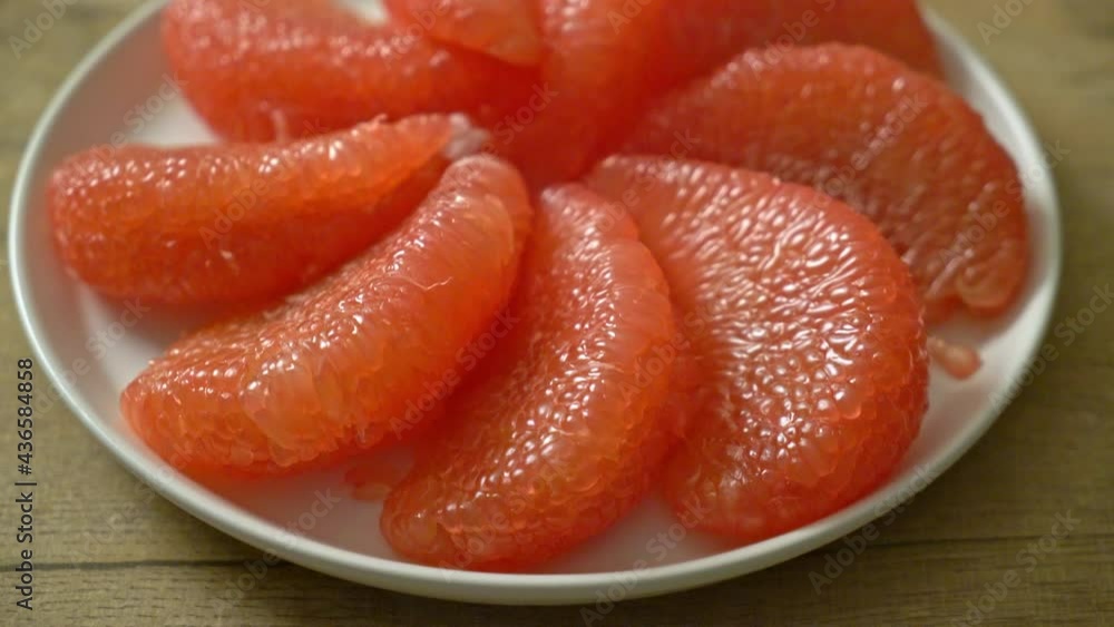 fresh red pomelo fruit or grapefruit on plate fresh red pomelo fruit or grapefruit on plate