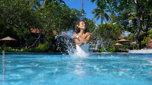 Bali as top travel destination. Young white woman enjoying her time in a pool during luxury holidays