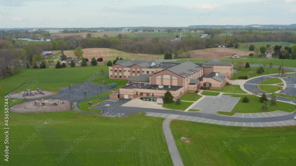 Aerial of modern America school building in USA. Education in America. Playground and rural farmland fields. Aerial of modern America school building in USA. Education in America. Playground and rural farmland fields.