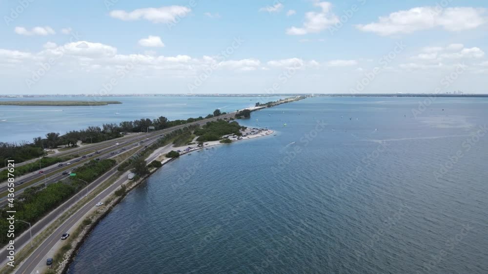 distant area view of the Sunshine Skyway tollway, kiteboarders and St. Pete, Tampa, Florida in the distant background distant area view of the Sunshine Skyway tollway, kiteboarders and St. Pete, Tampa, Florida in the distant background