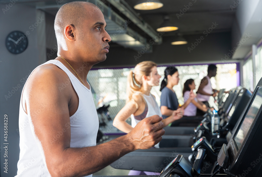 Man running on a treadmill in a sports club