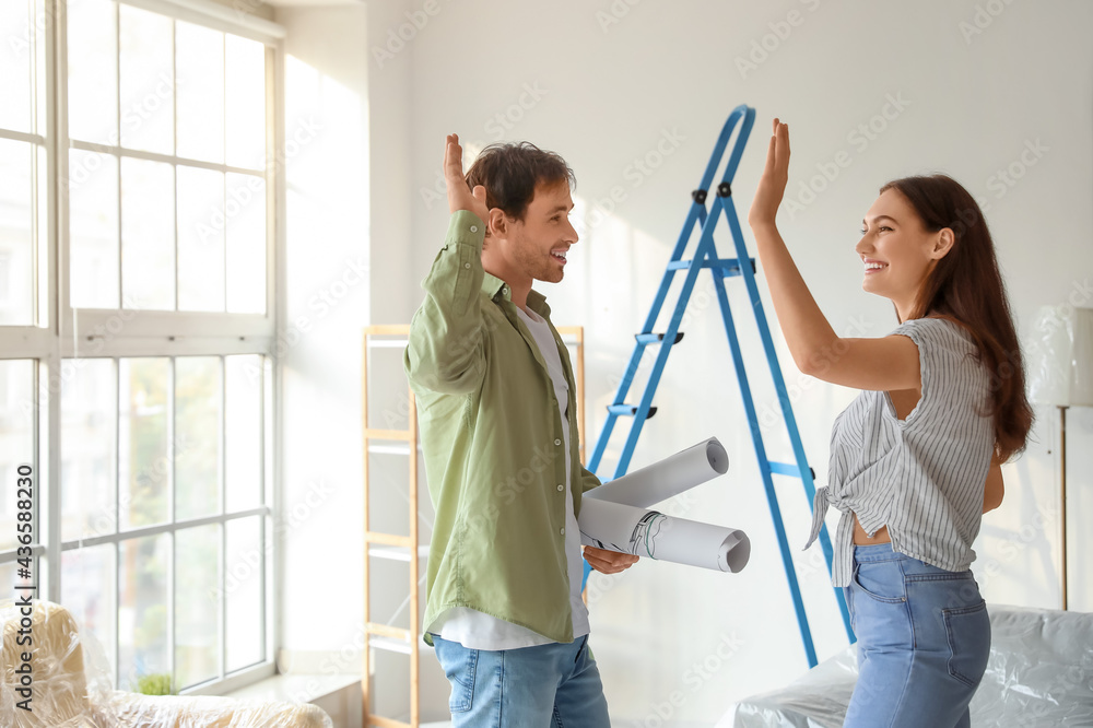 Happy couple planning design of their new house Happy couple planning design of their new house