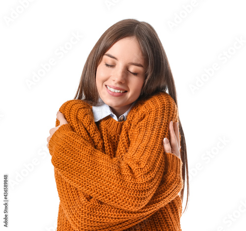 Young woman hugging herself...