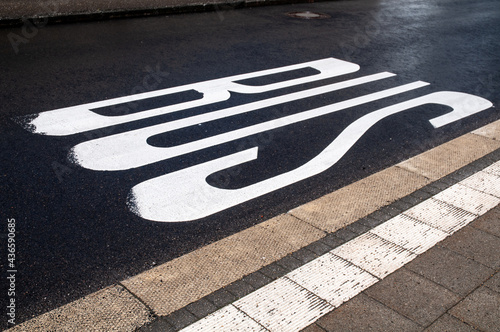 a tarmac street marked as a bus stop