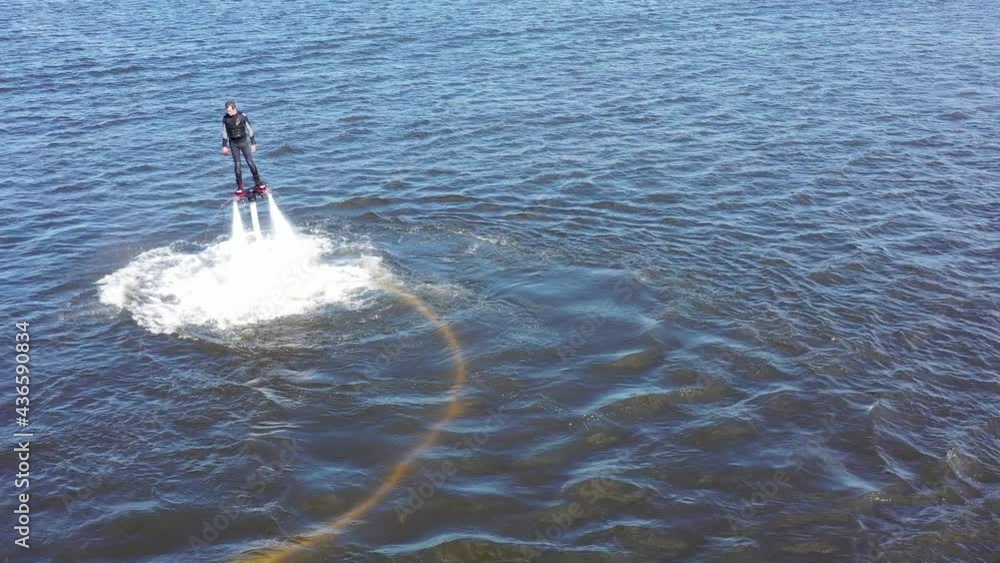 Man on the flyboard. Flyboard view from drone. Aerial view of water extreme  action sport. Guy is flying at the aquatic flyboard Stock Video | Adobe  Stock