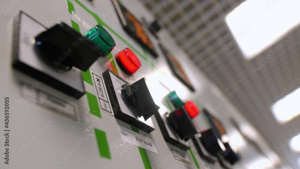 Motion past black plastic levers row on switchgear in light hall of ...