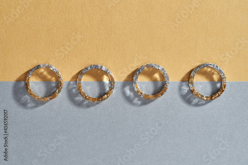 Transparent plastic rings with golden and silver filling