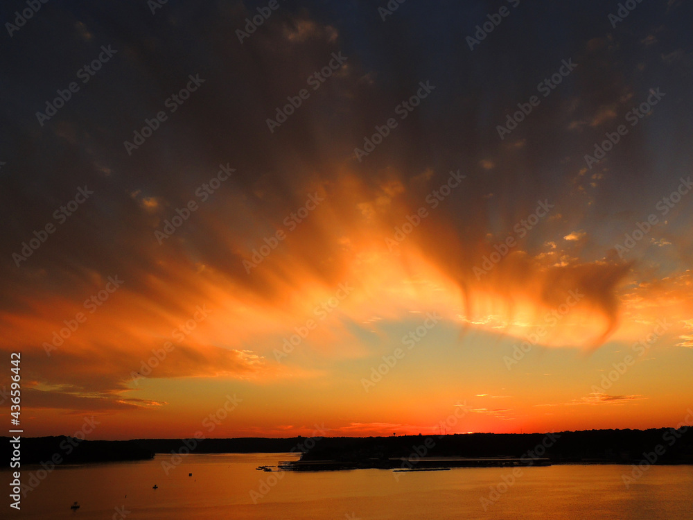 brilliant sunset in osage beach,  over the water at lake of the ozarks, missouri   