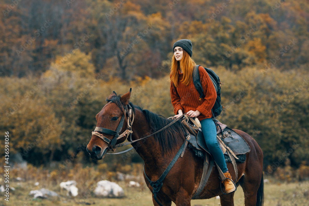 woman riding a horse on nature mountains travel adventure woman riding a horse on nature mountains travel adventure