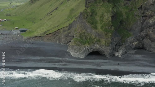 Mythical coast of Iceland with famous Halsanefshellir cave and black sand photo