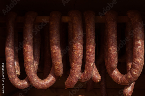 Homemade smoked sausage. Sausage. Sausage production. 