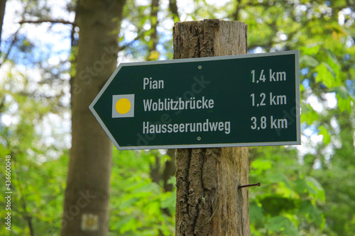 Guide post along  circular hiking trail to village 