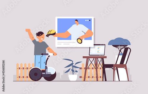 schoolboy riding electrical scooter and discussing with instructor in web browser window during video call