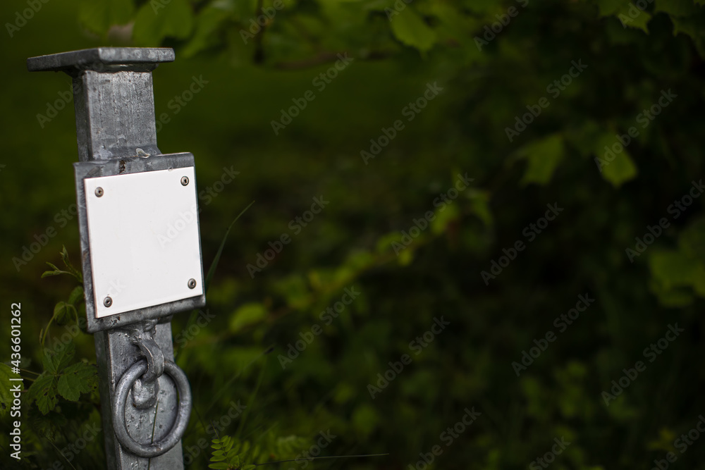 metal post with blank white sign