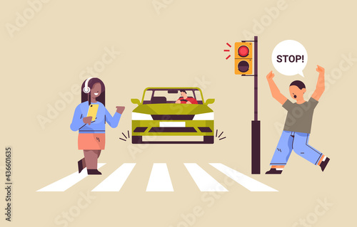 schoolgirl with smartphone and headphones crossing road on red traffic lights driver stops car immediately road safety