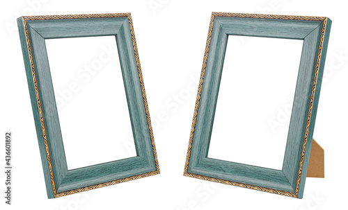 Set of two vertical standing empty large dark green wooden frames for photo or painting with decorative golden border isolated on white background