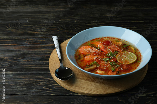 Tasty Tom yum soup on wooden background