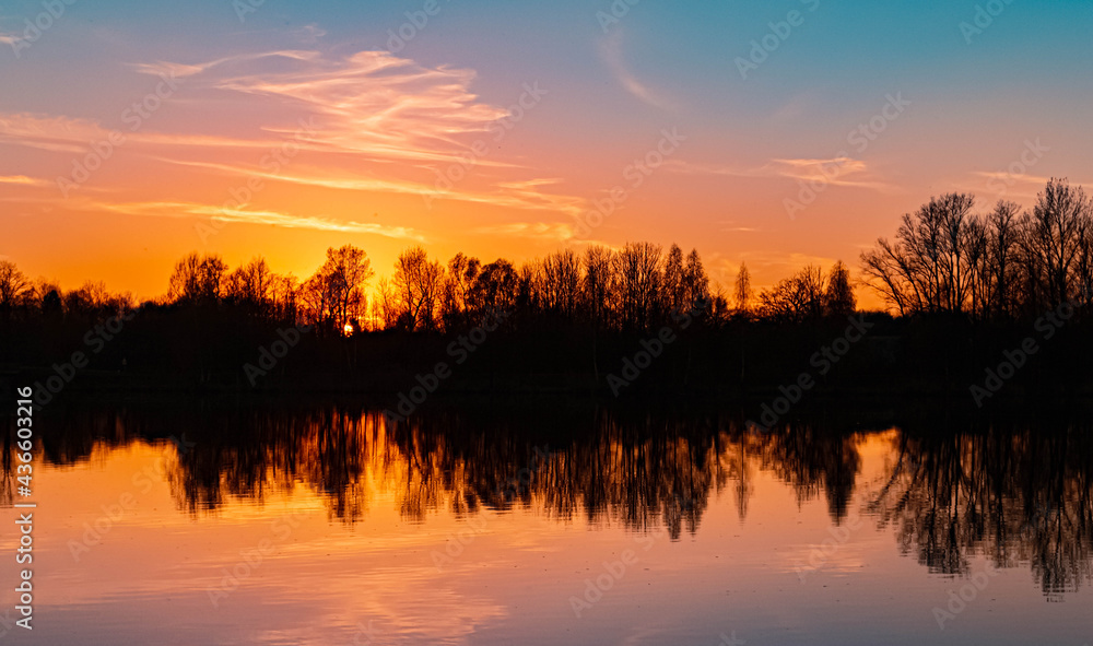 Beautiful spring sunset with reflections near Niederpoering, Bavaria, Germany