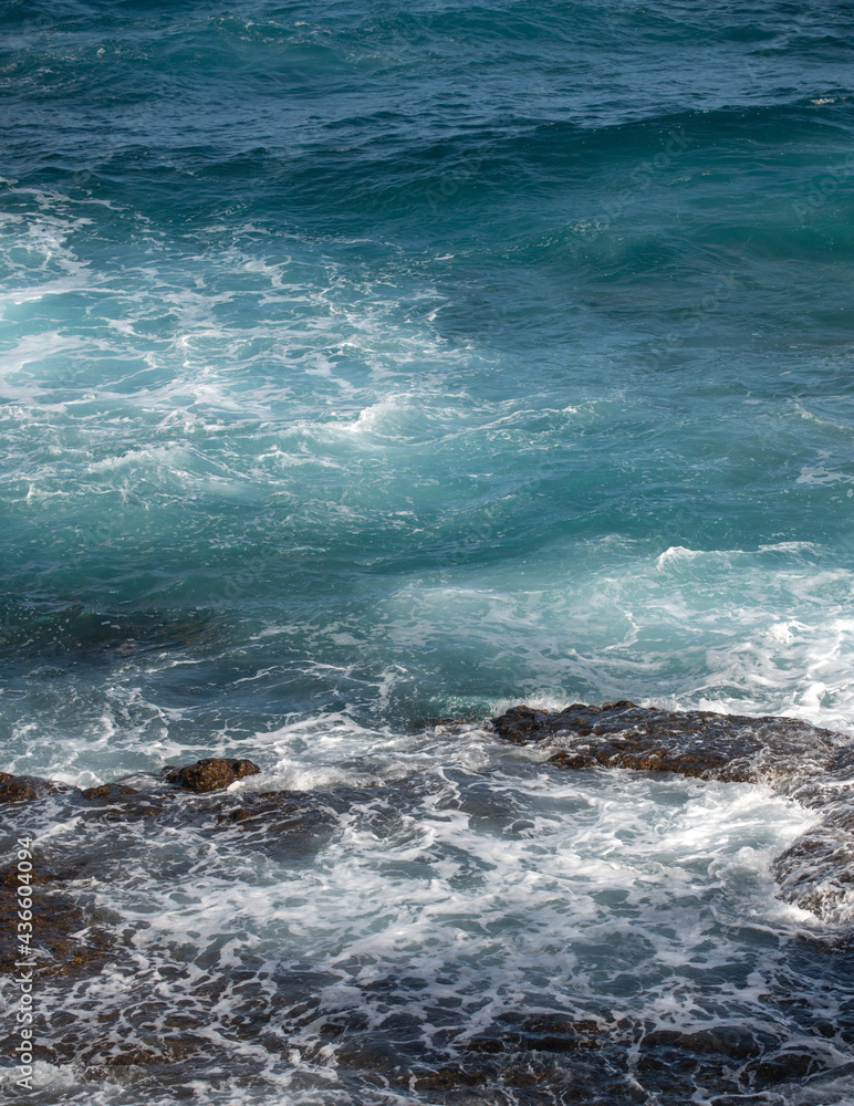 Sea background. Ocean wave crashing on rock coast with spray and foam before storm. Sea background. Ocean wave crashing on rock coast with spray and foam before storm.