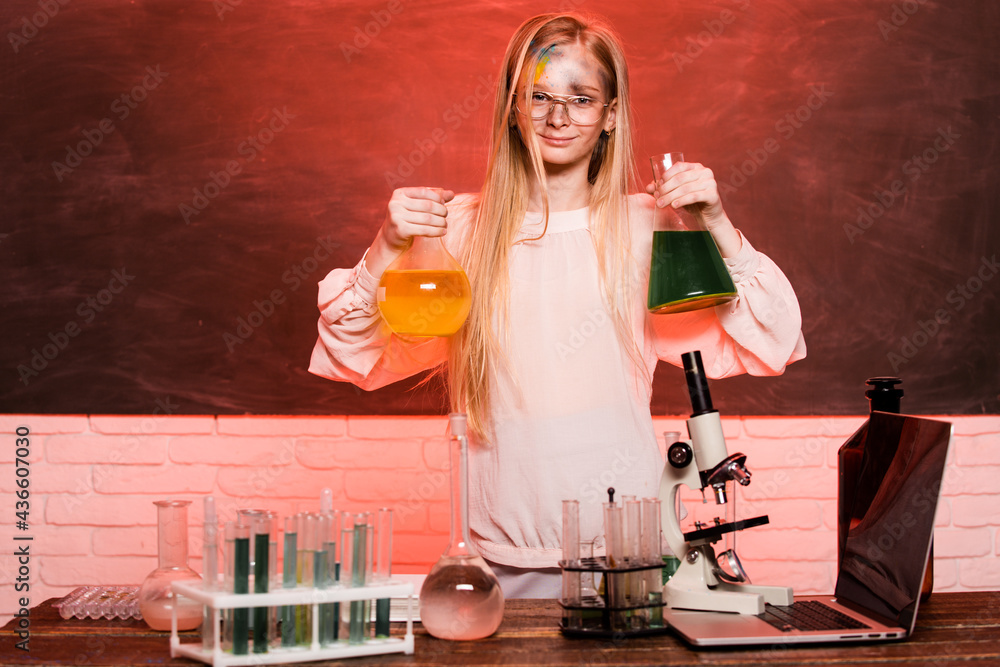 Science and school education. Funny girl doing experiments in the laboratory. Explosion in the laboratory. Kid scientist. Science and school education. Funny girl doing experiments in the laboratory. Explosion in the laboratory. Kid scientist.