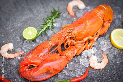 Fresh lobster food on dark plate background, Red lobster dinner seafood with herb spices lemon rosemary on ice in the restaurant gourmet food healthy boiled lobster cooked