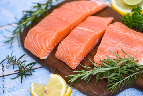 Fresh salmon fish, Raw salmon filet with lemon rosemary herbs and spices