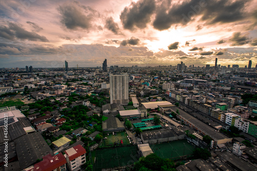 The high angle background of the city view with the secret light of the evening, blurring of night lights, showing the distribution of condominiums, dense homes in the capital community