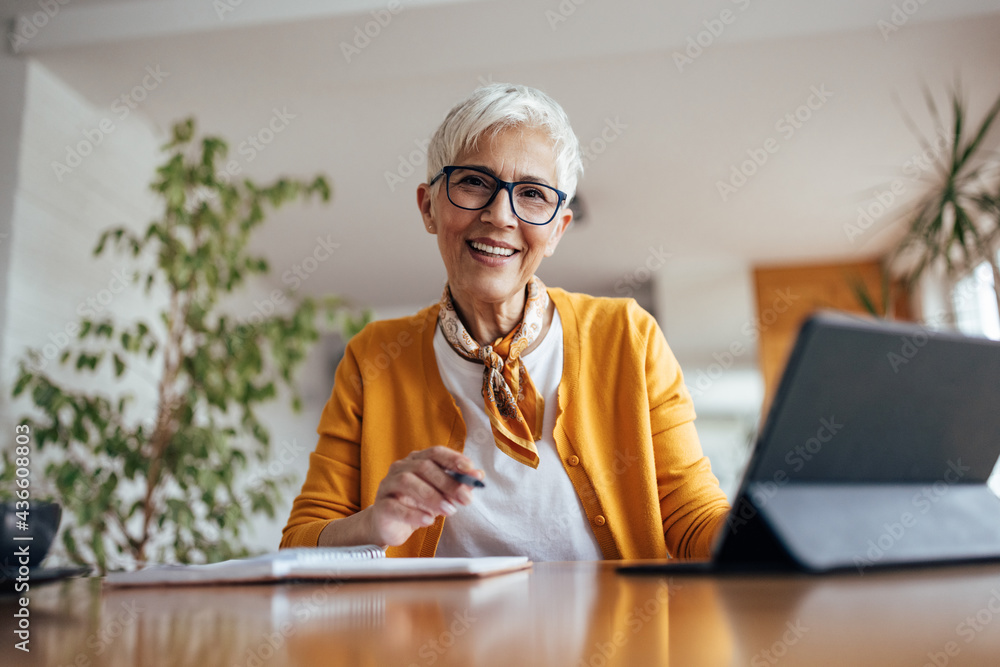 © bnenin - Senior woman, happily posing at home office. © bnenin - Senior woman, happily posing at home office.