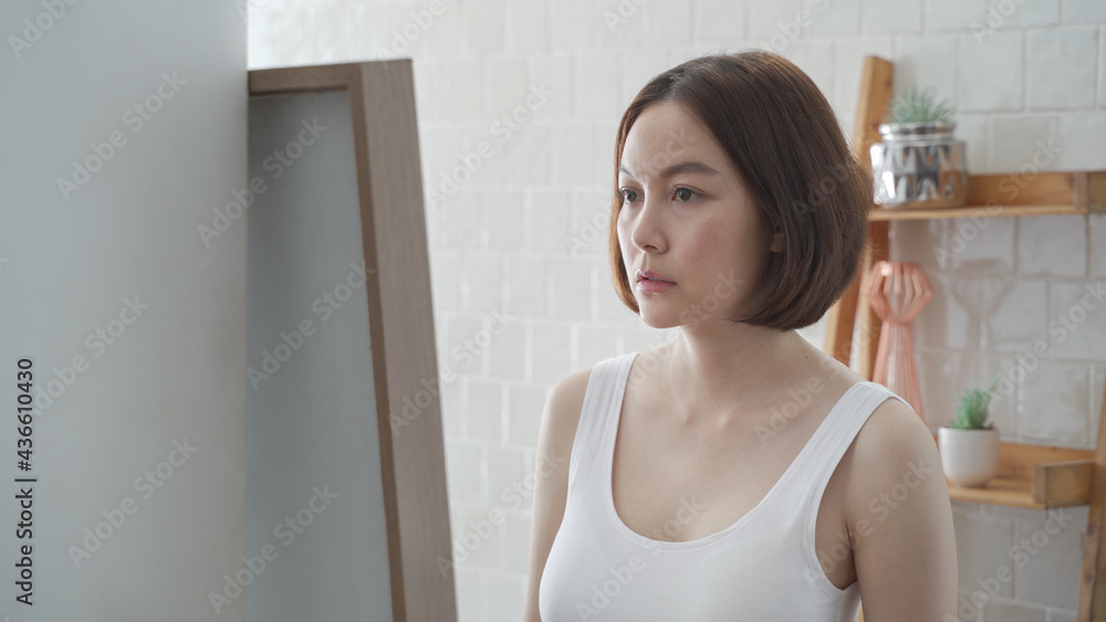 attractive beautiful short hair asian woman worry looking into mirror for face skin care condition. Frustrated Young female Examining Her Face While Looking At The Mirror in bathroom. annoy facial age attractive beautiful short hair asian woman worry looking into mirror for face skin care condition. Frustrated Young female Examining Her Face While Looking At The Mirror in bathroom. annoy facial age
