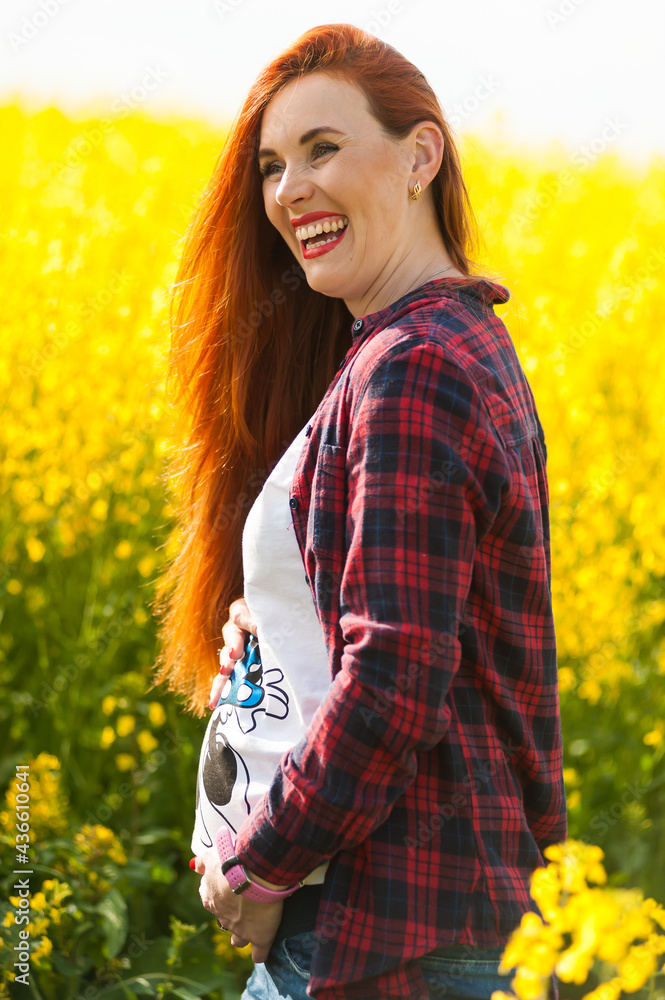Pregnant woman on the summer field