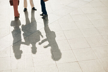 Business people standing outdoors on tile floor and talking about project they are currently working on