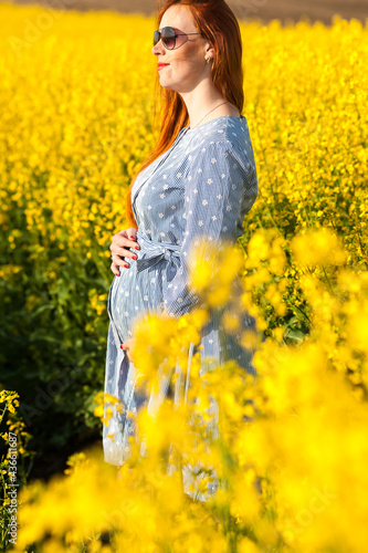 Pregnant woman portrait on the field