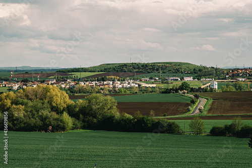 view from the hill to a small Czech village, summer landscape with green fields