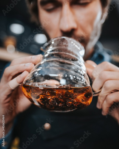 Blurred cascara drink in a glass teapot - dried coffee pulp, called coffee tea photo