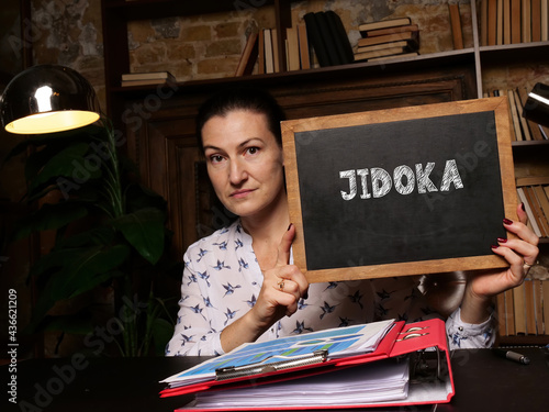 Business concept about JIDOKA with inscription on black chalkboard. photo