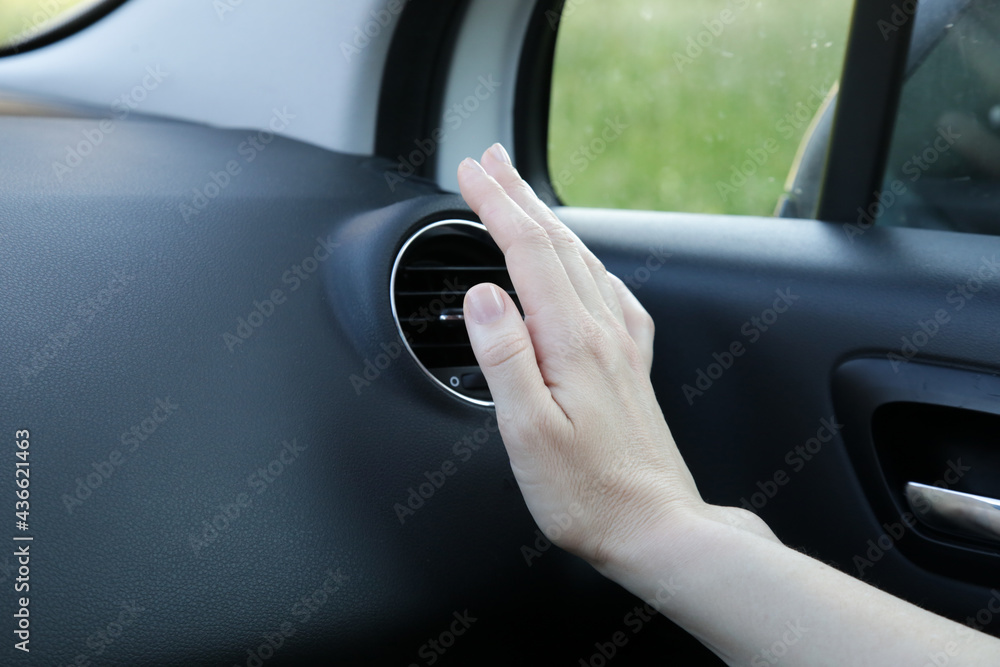 Hand checking the air conditioner in the car Hand checking the air conditioner in the car