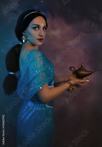 Beautiful Jasmine princess closeup with magic lamp in her hands. Art photo