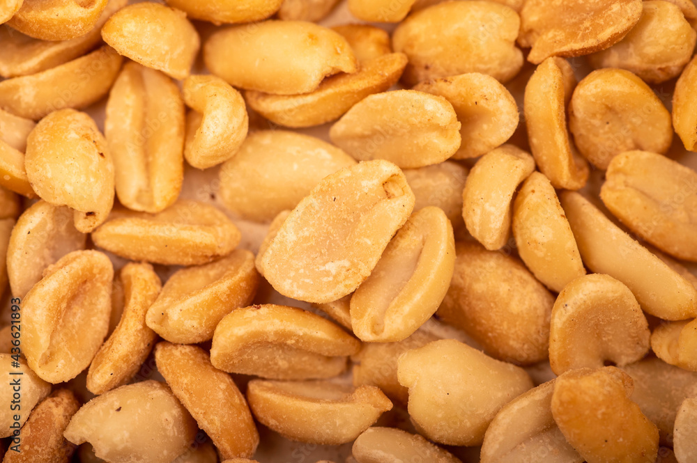 Roasted salted peanuts, surface texture. Close-up, selective focus. Roasted salted peanuts, surface texture. Close-up, selective focus.
