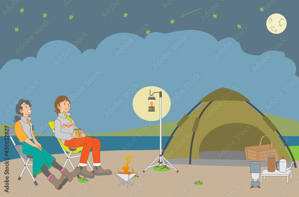 夜に湖畔のキャンプで友人と天体観測を楽しむ女性