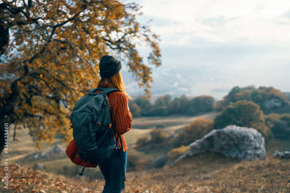 woman hiker backpack in travel mountains autumn lifestyle