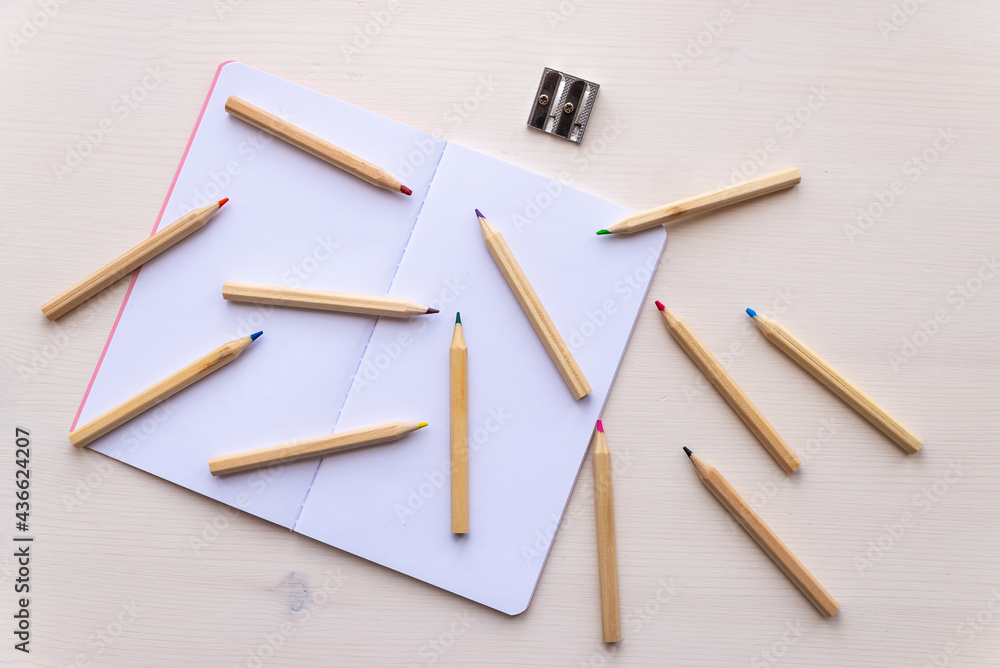 custom made wallpaper toronto digitalOpen white notebook, with colored crayons beside it, penknife and drawing of a colored flower. 