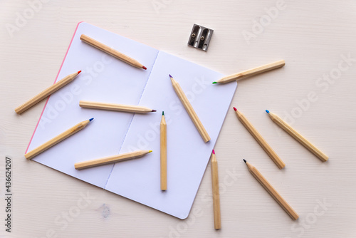 Wallpaper Mural Open white notebook, with colored crayons beside it, penknife and drawing of a colored flower.  Torontodigital.ca